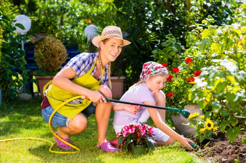 Professional gardeners following a health and safety policy during maintenance